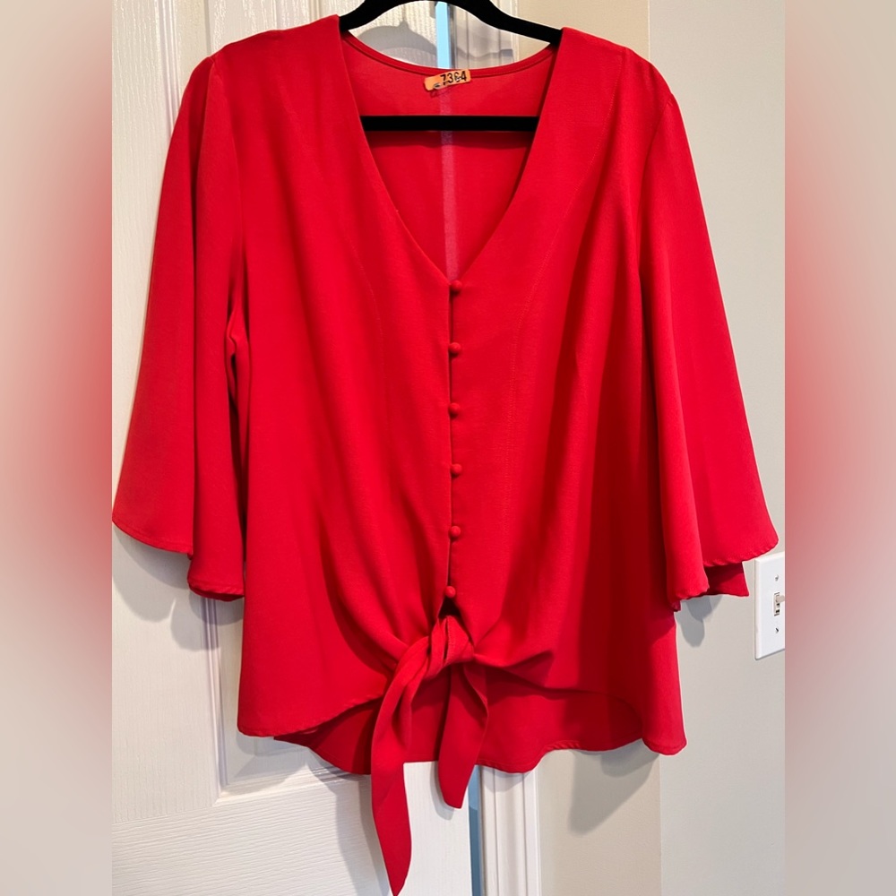 Red blouse.  Bell sleeves, tie front.  Dress up or down.  Holiday party wear too